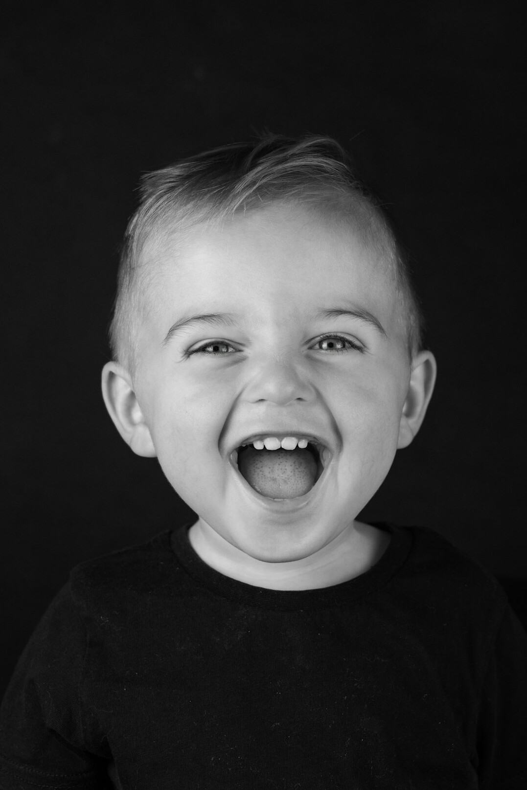 Studio portrait of a man with short hair smiling