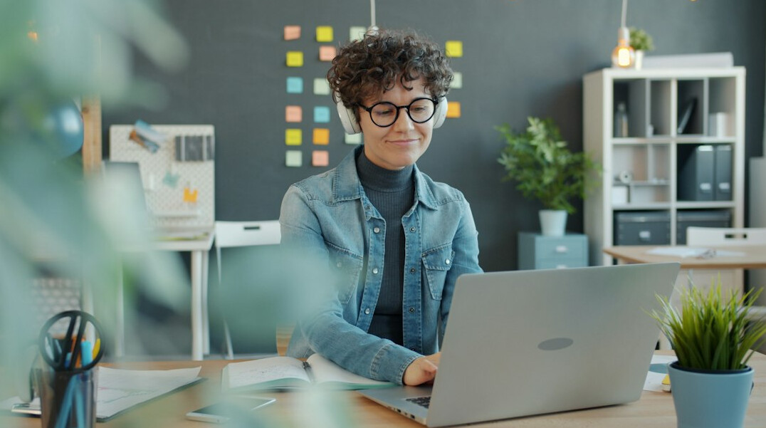 woman coding at home desk
