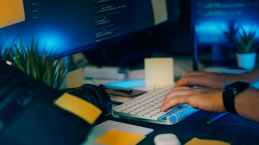 successful programmer at desk